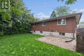 Guelph (Kortright West) apartment for rent - A red brick house with a green lawn in front.
