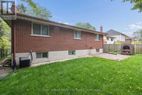 Guelph (Kortright West) apartment for rent - A red brick house with a green lawn in front.