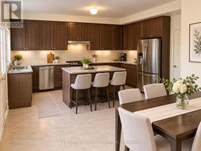 Brampton (Sandringham-Wellington) apartment for rent - A kitchen with brown cabinets and a dining table with chairs.