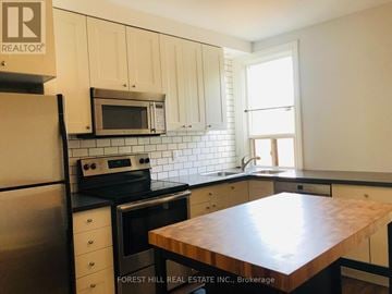 Toronto (Wychwood) apartment for rent - A kitchen with Forest Hill Real Estate Inc. signage.