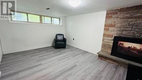 Markham (Royal Orchard) apartment for rent - A room with a fireplace and a chair.