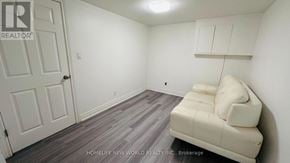 Markham (Royal Orchard) apartment for rent - A white couch sits in a room with a white door and a white wall.