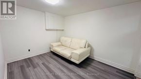 Markham (Royal Orchard) apartment for rent - A white couch sits in a room with a wooden floor and white walls.