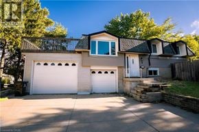 Kitchener apartment for rent - A two-story house with a garage and a driveway.