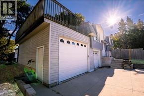 Kitchener apartment for rent - A house with a balcony and a garage door.