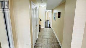 Brampton (Bram West) townhouse for rent - A hallway with a tiled floor and white walls.