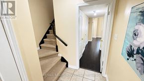 Brampton (Bram West) townhouse for rent - A hallway with a staircase leading to a landing with a doorway.