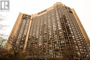 Toronto (Waterfront Communities) condo for rent - A tall building with a lot of windows and a sign that says HomeLife Excision Realty Inc.