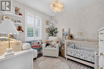 Toronto (East York) apartment for rent - A nursery room with a white crib and a teddy bear.