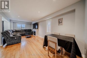 Barrie (Innis-Shore) apartment for rent - A living room with a grey couch and a black tablecloth on the table.