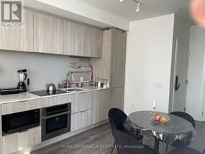 Mississauga (Port Credit) condo for rent - A modern kitchen with a table set for two.