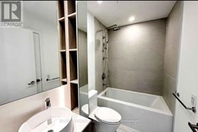 Mississauga (Port Credit) condo for rent - A bathroom with a toilet, sink, and bathtub.