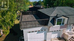 Kitchener apartment for rent - A house with a grey roof and a white garage door.