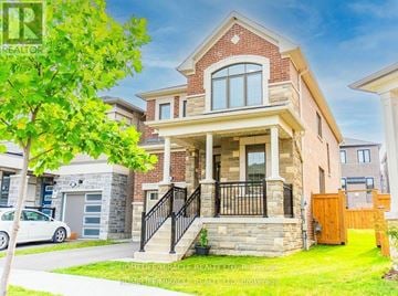 Pickering apartment for rent - A brick house with a white car parked in front.