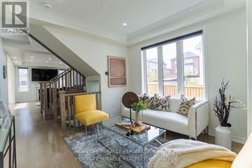 Pickering apartment for rent - A living room with a white couch and a glass coffee table.