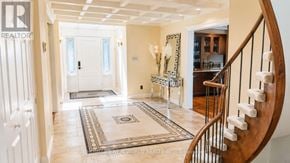 Markham (Thornhill) apartment for rent - A hallway with a wooden staircase and a rug on the floor.