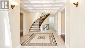 Markham (Thornhill) apartment for rent - A hallway with a staircase and a rug in the middle.