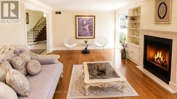 Markham (Thornhill) apartment for rent - A living room with a grey couch, a fireplace, and a painting on the wall.