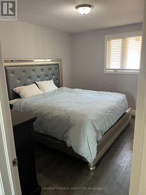 Bradford West Gwillimbury (Bradford) apartment for rent - A bedroom with a bed, nightstand, and window.