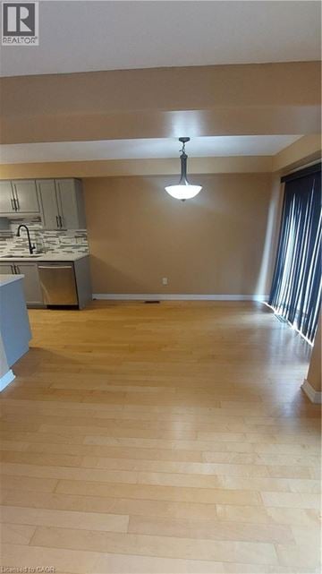 Binbrook townhouse for rent - A kitchen with wooden floors and a hanging light fixture.