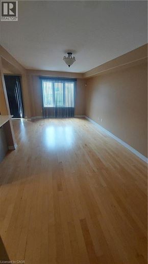 Binbrook townhouse for rent - A room with wooden flooring and a window with blinds.