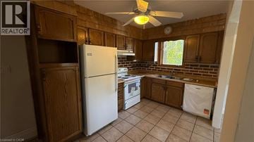 Burlington apartment for rent - A kitchen with wooden cabinets and a white refrigerator.