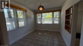 Burlington apartment for rent - A room with a tiled floor and a window with a view of trees.