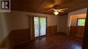 Burlington apartment for rent - A room with wooden floors and a ceiling fan.