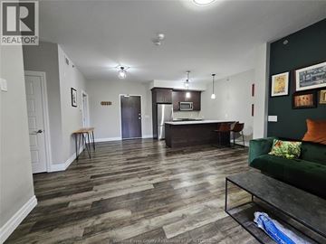 Lasalle condo for rent - A living room with a kitchen area in the background.