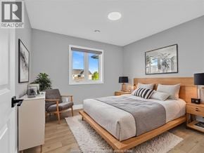Cottam apartment for rent - A bedroom with a large bed, a chair, and a window.