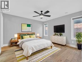 Cottam apartment for rent - A bedroom with a bed, nightstands, and a television.