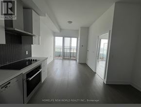 Toronto (Mimico) condo for rent - A modern kitchen with a stove top oven and a large window.