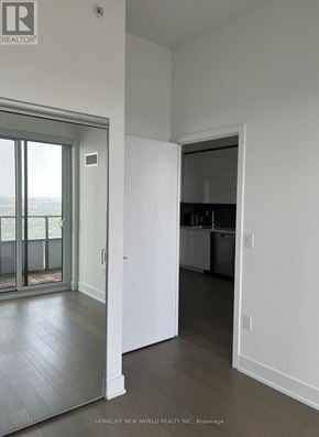 Toronto (Mimico) condo for rent - A brokerage sign is on the wall of a white room.