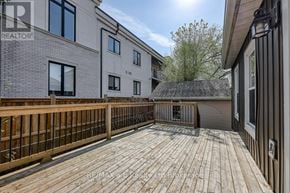 Woodstock (Woodstock - South) apartment for rent - A wooden deck in front of a building with a sign that reads REALTOR.