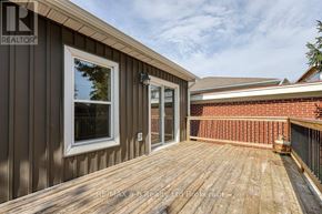 Woodstock (Woodstock - South) apartment for rent - A wooden deck with a sliding glass door and a window.