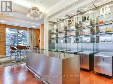 Toronto (Bendale) condo for rent - A modern kitchen with a glass display cabinet and a wooden floor.