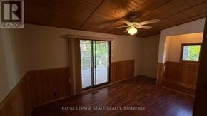 Burlington (Lasalle) apartment for rent - A room with wooden walls and a ceiling fan.