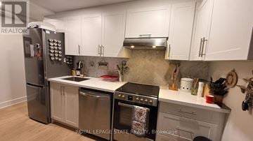 Hamilton (Randall) apartment for rent - A kitchen with a stainless steel refrigerator, oven, and dishwasher.