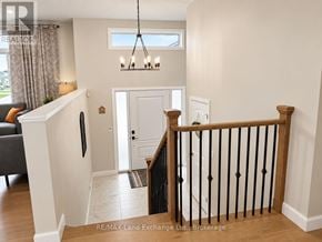 Saugeen Shores apartment for rent - A white interior with a black railing and a chandelier.