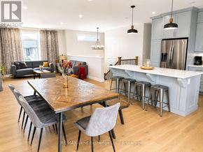 Saugeen Shores apartment for rent - A modern kitchen and dining area with a wooden table and grey chairs.