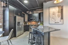 London North (North E) condo for rent - A modern kitchen with a large island and stainless steel appliances.