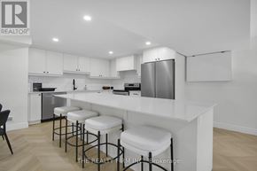London North (North O) apartment for rent - A modern kitchen with white cabinets and a bar area.