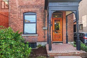 Ottawa apartment for rent - A red brick house with a wooden door and a window.