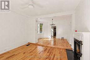 Ottawa apartment for rent - A room with wooden floors and a fireplace.