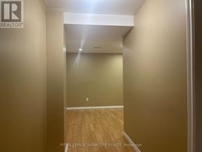 Brampton (Fletcher's Meadow) apartment for rent - A hallway with wooden floors and white walls.