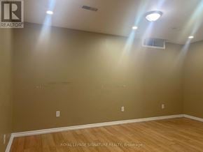 Brampton (Fletcher's Meadow) apartment for rent - A room with wooden flooring and beige walls.
