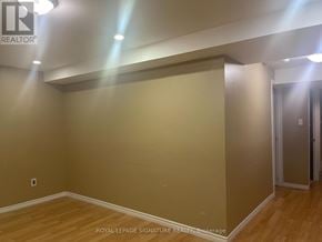 Brampton (Fletcher's Meadow) apartment for rent - A room with wooden flooring and a Royal LePage sign on the wall.