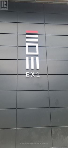 Mississauga (City Centre) condo for rent - Exit sign on a building with a grey background.
