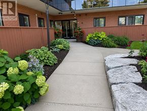 Midland multi-family for rent - A garden with a stone pathway leading to a building entrance.