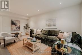 Toronto (The Beaches) apartment for rent - A living room with a sofa, armchair, and coffee table.